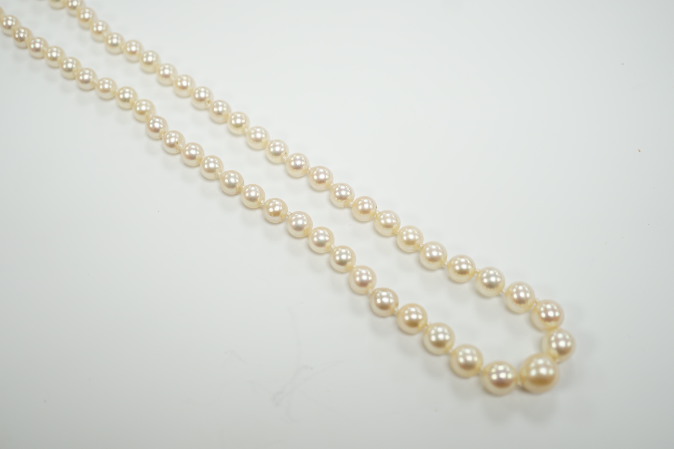 A single strand graduated cultured pearl necklace, with turquoise and diamond set yellow metal clasp, 58cm.